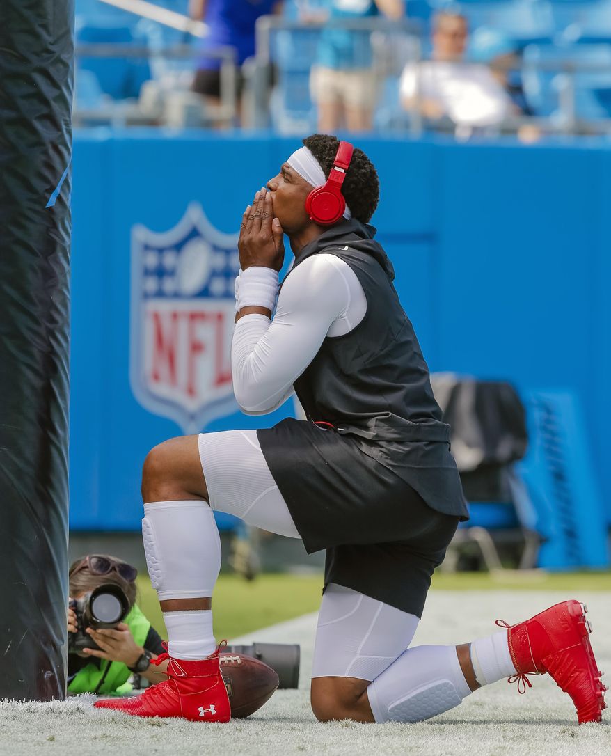 FILE - In this Sept. 17, 2017, file photo, Carolina Panthers&#x27; Cam Newton finishes a prayer before an NFL football game between against the Buffalo Bills in Charlotte, N.C. The Panthers defense has been dominant in the first two weeks of the season, but Cam Newton and the offense know they&#x27;re going to have to start completing drives and scoring touchdowns instead of field goals. (AP Photo/Bob Leverone, File)