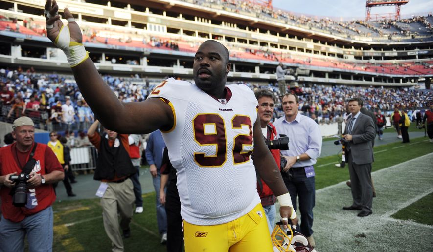 Washington Redskins defensive tackle Albert Haynesworth (92) throws souvenirs to the fans as he leaves the field after the Redskins beat the Tennessee Titans 19-16 in overtime during an NFL football game on Sunday, Nov. 21, 2010, in Nashville, Tenn. (AP Photo/Joe Howell)