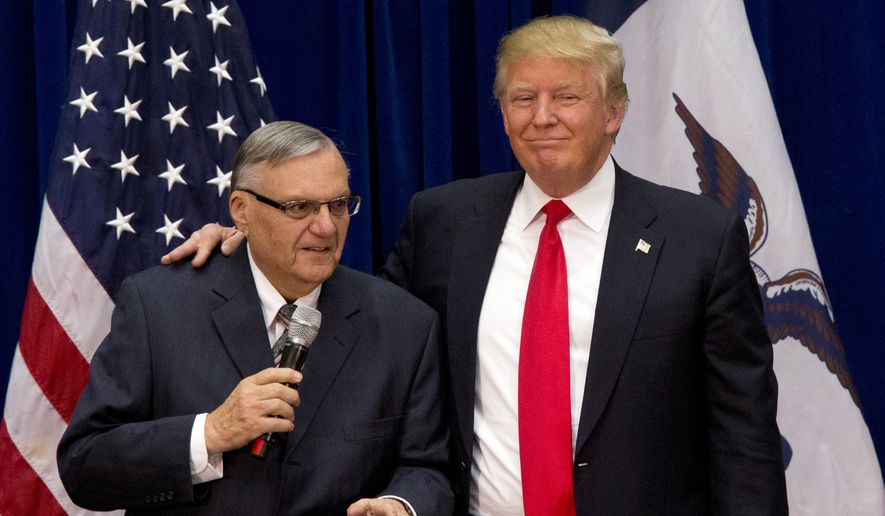 In this Jan. 26, 2016, file photo, then-Republican presidential candidate Donald Trump is joined by Joe Arpaio, the sheriff of metro Phoenix, at a campaign event in Marshalltown, Iowa. (AP Photo/Mary Altaffer, File)