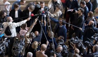 Lawyers for Mehdi Nemmouche, a French suspect in the Brussels Jewish museum attack, Henri Laquay, top center left, and Sebastien Courtoy, top center right, speak with the media at the Palace of Justice in Brussels on Thursday, Sept. 21, 2017. Mehdi Nemmouche, who is suspected of shooting dead four people at the Jewish Museum in Brussels on May 24, 2014, has complained to his lawyers that his health is deteriorating in custody. (AP Photo/Virginia Mayo)