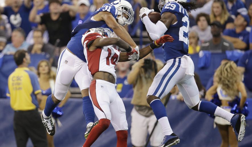 FILE - In this Sunday, Sept. 17, 2017, file photo, Indianapolis Colts' Malik Hooker (29) makes an interception on a pass intended for Arizona Cardinals' J.J. Nelson, center, during the first half of an NFL football game in Indianapolis. At left is Colts cornerback Quincy Wilson (31). Hooker missed all of Indy’s offseason team activities while recovering from surgery and was limited throughout training camp by as assortment of other nicks. Wilson, meanwhile, got plenty of action in camp but the Colts worked him into the lineup slowly. (AP Photo/AJ Mast, File)