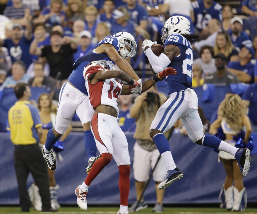 FILE - In this Sunday, Sept. 17, 2017, file photo, Indianapolis Colts' Malik Hooker (29) makes an interception on a pass intended for Arizona Cardinals' J.J. Nelson, center, during the first half of an NFL football game in Indianapolis. At left is Colts cornerback Quincy Wilson (31). Hooker missed all of Indy’s offseason team activities while recovering from surgery and was limited throughout training camp by as assortment of other nicks. Wilson, meanwhile, got plenty of action in camp but the Colts worked him into the lineup slowly. (AP Photo/AJ Mast, File)
