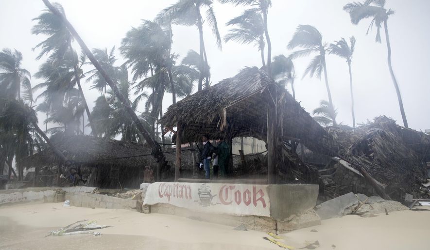 A person looks out from the Captain Cook restaurant damaged during the crossing of Hurricane Maria, on Cofrecito Beach, in Bavaro, Dominican Republic, Thursday, Sept. 21, 2017.  Rain from the storm will continue in the Dominican Republic for the next two days according to meteorologists.(AP Photo/Tatiana Fernandez)