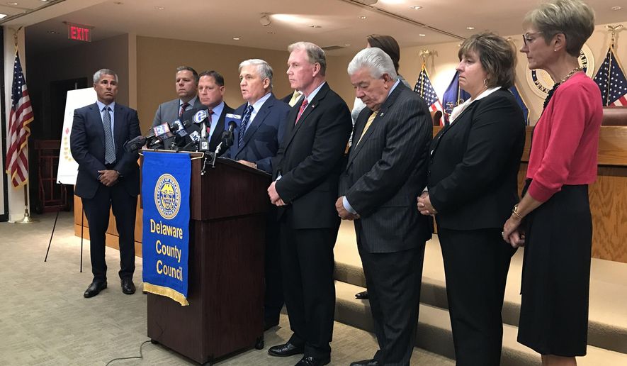 Delaware County, Pa. officials announce the filing of a lawsuit Thursday, Sept. 21, 2017, against 11 makers of opiod painkillers, hoping to stem the tide of drug deaths and overdoses, in Media, Pa. Delaware County sued 11 pharmaceutical companies Thursday for marketing tactics they said misrepresented the dangers of long-term opioid usage amid a national overdose crisis that continues to kill tens of thousands of people annually.   (Erin McCarthy/The Philadelphia Inquirer via AP)