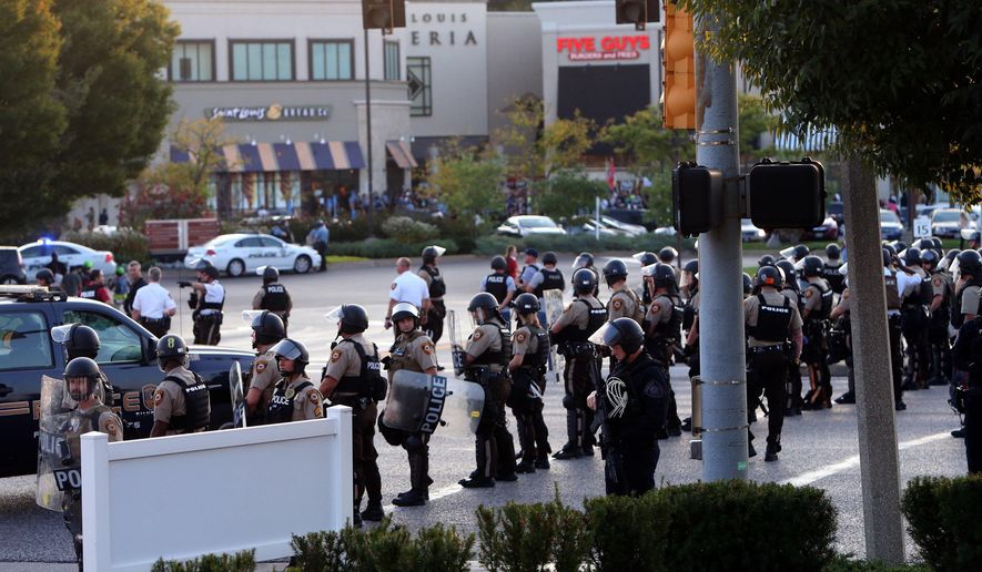 Police dressed in riot gear stage in the front of the  Saint Louis Galleria mall to clear protesters from the streets on Wednesday, Sept. 20, 2017, in St. Louis. St. Louis County police say they broke up a demonstration near the upscale mall because protesters weren&#39;t listening to instructions and tried to evade two lines of officers blocking the on-ramp to a highway. The protesters broke into groups, with some milling around near the highway entrance, some in the mall parking lot and others on a nearby street. (Laurie Skrivan/St. Louis Post-Dispatch via AP)
