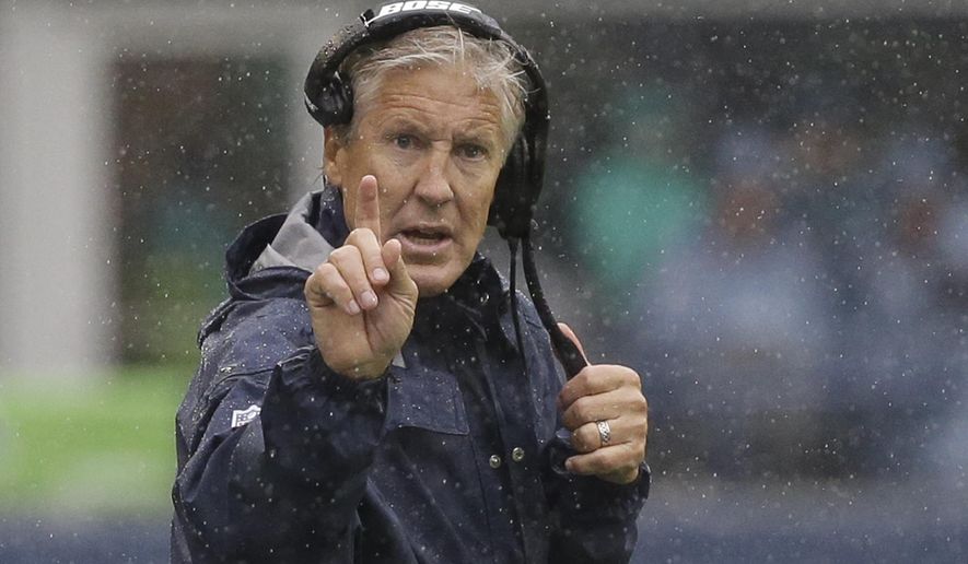 FILE - In this Sunday, Sept. 17, 2017, file photo, Seattle Seahawks head coach Pete Carroll gestures from the sideline in the rain during the first half of an NFL football game against the San Francisco 49ers in Seattle. Carroll has been studying Dick LeBeau since he went into coaching himself, and now the Seattle head coach finds himself facing off again against the defensive coordinator now with the Tennessee Titans. (AP Photo/Elaine Thompson, File)