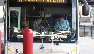 FILE - In this March 2, 2016 file photo, a passenger boards a city bus while the driver looks on at the bus station in downtown Reno, Nev. A federal judge has given northern Nevada&#39;s largest public transit system the green light to begin recording audio along with video surveillance on city buses despite objections from the bus drivers&#39; union that it&#39;s an illegal invasion of privacy. U.S. District Judge Miranda Du said in a ruling this week neither the drivers nor their passengers have a right to privacy because conversations on public buses are not private. (AP Photo/Scott Sonner, File)