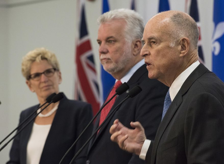 California Gov. Jerry Brown, right, speaks at new conference after signing an agreement on climate change in Quebec City, Canada, on Friday, Sept. 22, 2017. Ontario Premier Kathleen Wynne, left, and Quebec Premier Philippe Couillard, center look on. Brown noted that the administration of U.S. President Donald Trump may not have an agenda of fighting climate change, but that is why it is important for subnational governments to move forward. (Jacques Boissinot/The Canadian Press via AP)