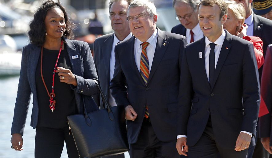French President Emmanuel Macron, right, International Olympic Committee (IOC) President Thomas Bach, center, and French Minister for Sports Laura Flessel arrive for a meeting at the city hall as part of a visit to the site of the future Olympic Sailing venue (Voile Olympique) at the &amp;quot;Marina Olympique&amp;quot; nautical base in Marseille, southern France, after the decision for Paris to host of the 2024 Summer Olympics Games, Thursday, Sept. 21, 2017. (Jean-Paul Pelissier/Pool Photo via AP)