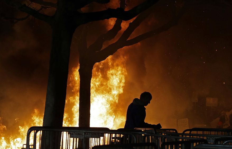 A fire by demonstrators protesting a scheduled speaking appearance by Breitbart News editor Milo Yiannopoulos burns on Sproul Plaza on the University of California, Berkeley campus, Feb. 1, 2017. AP Photo/Ben Margot) ** FILE **