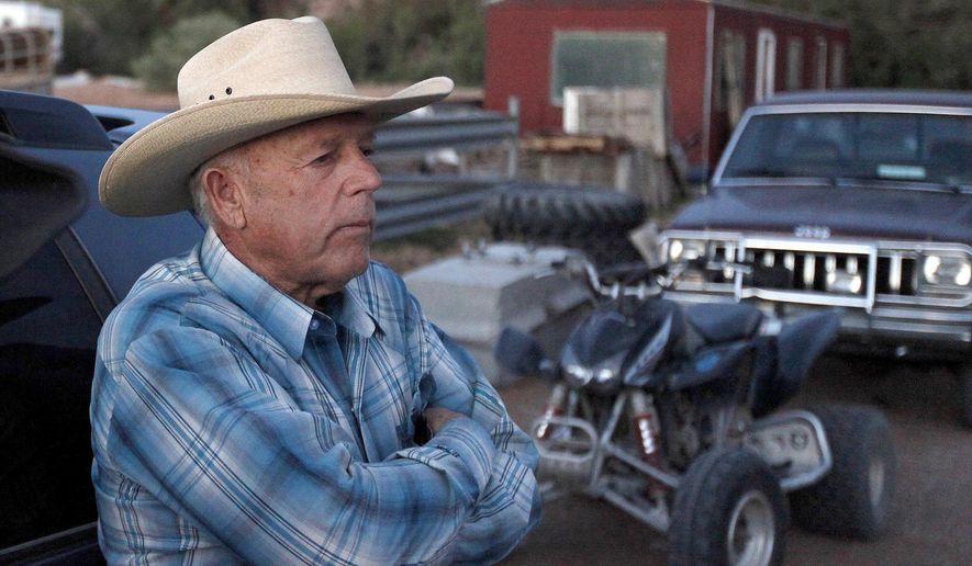 FILE - In this Saturday, April 5, 2014 file photo, Cliven Bundy, stands at the Bundy ranch near Bunkerville Nev. Bundy's defense attorney, Bret Whipple, is seeking to withdraw from Nevada cattleman and state's rights figure's case, less than three weeks before trial begins for Bundy and six other defendants. (John Locher/Las Vegas Review-Journal via AP, File)