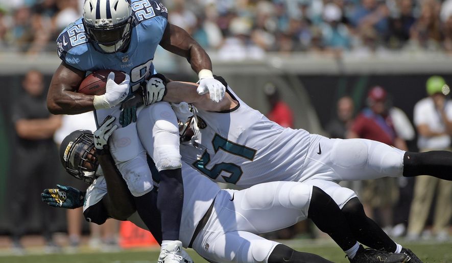 FILE - In this Sunday, Sept. 17, 2017, file photo, Tennessee Titans running back DeMarco Murray (29) is stopped by Jacksonville Jaguars outside linebacker Myles Jack, left, and middle linebacker Paul Posluszny (51) during the first half of an NFL football game in Jacksonville, Fla. Murray, who has missed two straight practices, is expected back on the field Friday before Tennessee hosts Seattle on Sunday. (AP Photo/Phelan M. Ebenhack, File)