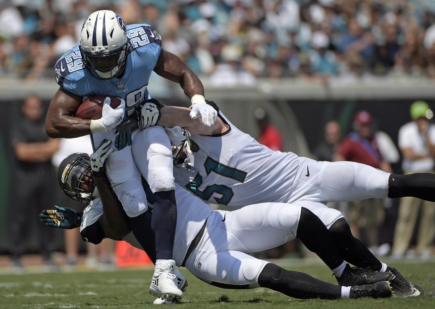 FILE - In this Sunday, Sept. 17, 2017, file photo, Tennessee Titans running back DeMarco Murray (29) is stopped by Jacksonville Jaguars outside linebacker Myles Jack, left, and middle linebacker Paul Posluszny (51) during the first half of an NFL football game in Jacksonville, Fla. Murray, who has missed two straight practices, is expected back on the field Friday before Tennessee hosts Seattle on Sunday. (AP Photo/Phelan M. Ebenhack, File)
