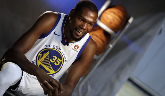 Golden State Warriors&#x27; Kevin Durant conducts an interview during NBA basketball team media day Friday, Sept. 22, 2017, in Oakland, Calif. (AP Photo/Marcio Jose Sanchez)
