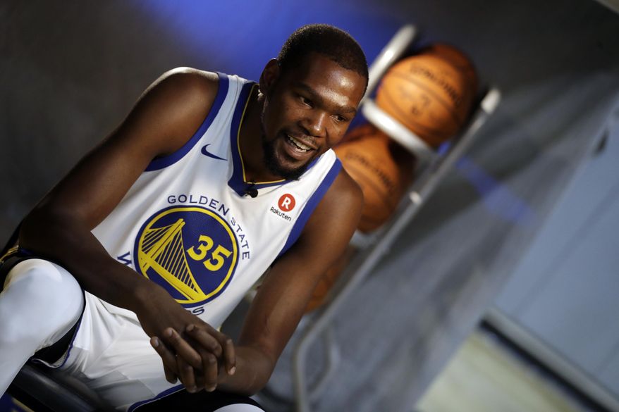Golden State Warriors&#x27; Kevin Durant conducts an interview during NBA basketball team media day Friday, Sept. 22, 2017, in Oakland, Calif. (AP Photo/Marcio Jose Sanchez)