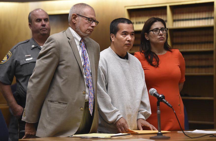 Lishan Wang, center, appears in court with Chief Public Defender Thomas Ullmann, left, during his sentencing at New Haven Superior Court Friday, Sept. 22, 2017 in New Haven, Conn. Wang, convicted of killing a Yale University physician over a workplace dispute has been sentenced to 32 years in prison. The judge handed down the punishment Wang for the 2010 shooting death of Dr. Vajinder Toor. He pleaded no contest in June to manslaughter and other charges. (Brad Horrigan/The Courant via AP)