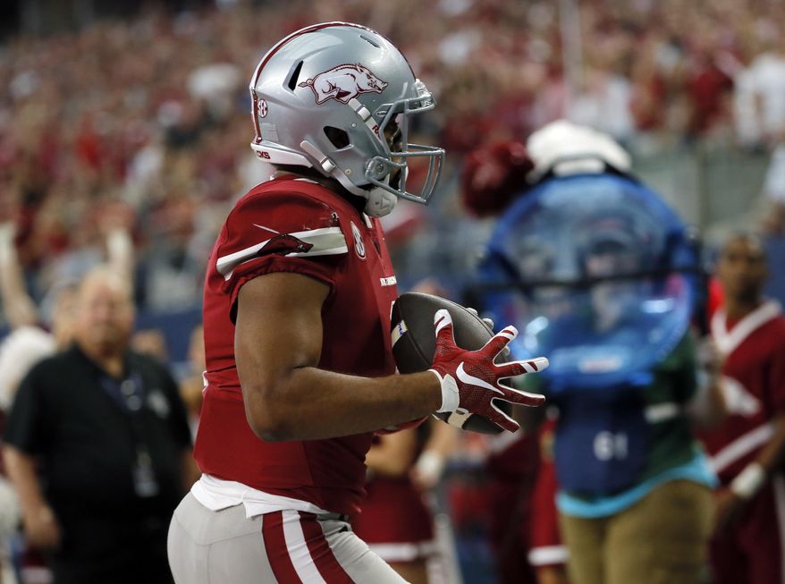 Arkansas wide receiver Jared Cornelius (1) catches a pass in the end zone for a touchdown in the first half of an NCAA college football game against Texas A&M, Saturday, Sept. 23, 2017, in Arlington, Texas. (AP Photo/Tony Gutierrez)