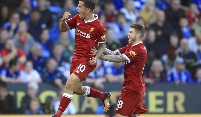 Liverpool&#x27;s Philippe Coutinho, left, celebrates scoring his side&#x27;s second goal of the game during the Premier League soccer match. Leicester City versus Liverpool at the King Power Stadium, Leicester, England,  Saturday Sept. 23, 2017. (Mike Egerton/PA via AP)