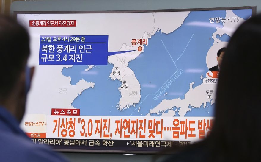 People watch a TV news program reporting North Korea's earthquake, at Seoul Railway Station in Seoul, South Korea, Saturday, Sept. 23, 2017. South Korea's weather agency said an earthquake was detected in North Korea on Saturday around where the country recently conducted a nuclear test, but it assessed the quake as natural. The signs read " The weather agency said a magnitude 3.0 earthquake was detected in North Korea." (AP Photo/Ahn Young-joon)