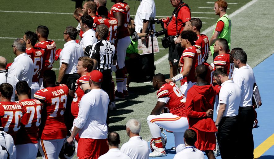 Members of the Kansas City Chiefs sit in protest during the National Anthem before an NFL football game against the Los Angeles Chargers Sunday, Sept. 24, 2017, in Carson, Calif. (AP Photo/Chris Carlson)