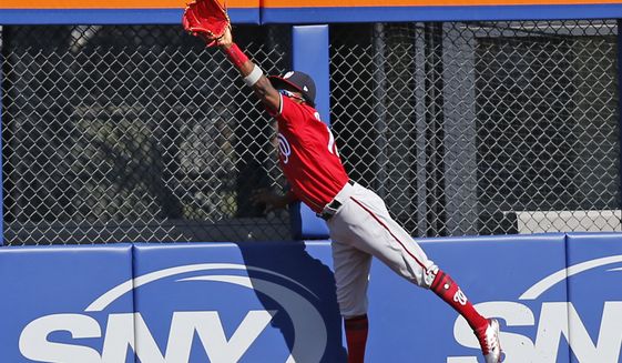 Washington Nationals right fielder Victor Robles (14) hauls in a fly ball hit by Jose Reyes during the first inning of a baseball game against the New York Mets, Sunday, Sept. 24, 2017, in New York. (AP Photo/Kathy Willens) ** FILE **