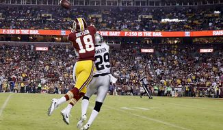 Washington Redskins wide receiver Josh Doctson (18) pulls in a touchdown pass under pressure form Oakland Raiders cornerback David Amerson (29) during the second half of an NFL football game in Landover, Md., Sunday, Sept. 24, 2017. (AP Photo/Alex Brandon)