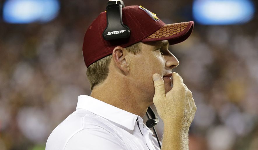 Washington Redskins head coach Jay Gruden watches from the sideline during the second half of an NFL football game against the Oakland Raiders in Landover, Md., Sunday, Sept. 24, 2017. (AP Photo/Mark Tenally)