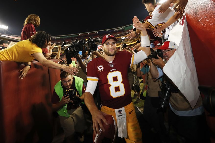 Washington Redskins quarterback Kirk Cousins (8) is greeted by fans as he leave the field after an NFL football game against the Oakland Raiders in Landover, Md., Sunday, Sept. 24, 2017. The Redskins defeated the Raiders 27-10. (AP Photo/Alex Brandon)