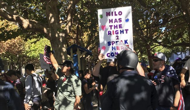 Berkeley Police officers stand guard for planned speech by Milo Yiannopoulos in Berkeley, Calif., Sunday, Sept. 24, 2017. Milo Yiannopoulos was whisked away in a car after a brief appearance at the school that drew a few dozen supporters and a slightly larger crowd protesting the right-wing provocateur. (AP Photo/Daisy Nguyen)
