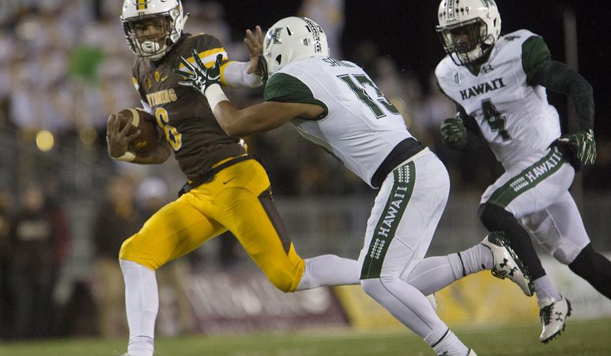 Wyoming running back Trey Woods (6) makes a run for the end zone as Hawaii defensive Back Keala Santiago (13) chases him during an NCAA college football game Saturday, Sept. 23, 2017, in Laramie, Wyo. (Josh Galemore/The Casper Star-Tribune via AP)