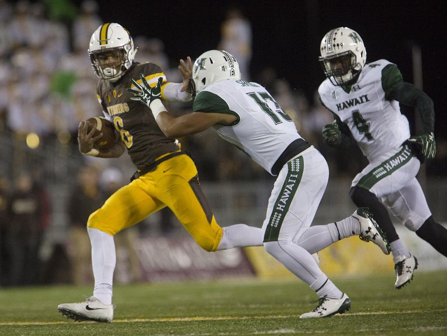 Wyoming running back Trey Woods (6) makes a run for the end zone as Hawaii defensive Back Keala Santiago (13) chases him during an NCAA college football game Saturday, Sept. 23, 2017, in Laramie, Wyo. (Josh Galemore/The Casper Star-Tribune via AP)