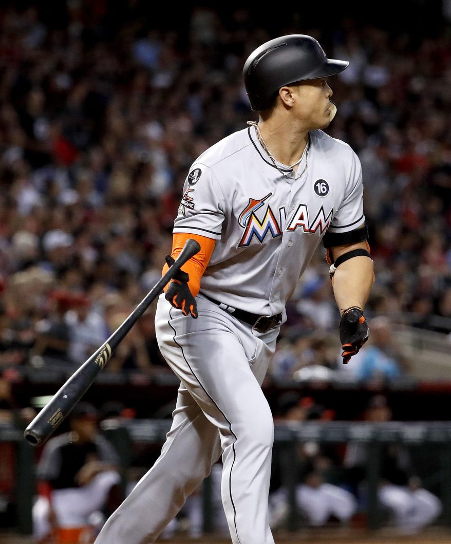 Miami Marlins' Giancarlo Stanton watches his solo home run against the Arizona Diamondbacks during the fourth inning of a baseball game, Saturday, Sept. 23, 2017, in Phoenix. (AP Photo/Matt York)