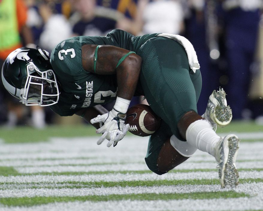 Michigan State's LJ Scott tries unsuccessfully to recover his fumble in the end zone during the second quarter against Notre Dame in an NCAA college football game, Saturday, Sept. 23, 2017, in East Lansing, Mich. The ball was recovered by Notre Dame. (AP Photo/Al Goldis)