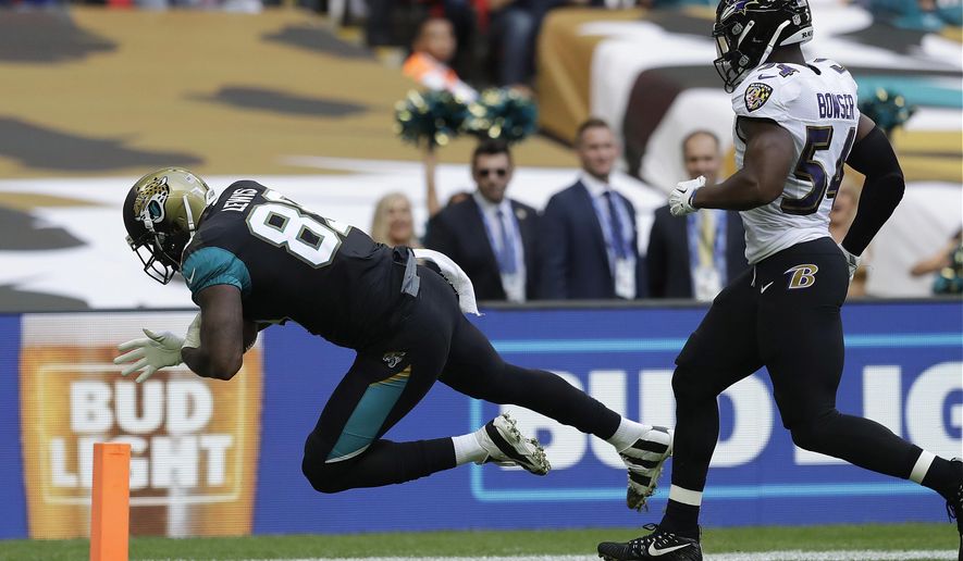 Jacksonville Jaguars tight end Marcedes Lewis (89) scores a touchdown in front of Baltimore Ravens linebacker Tyus Bowser during the first half of an NFL football game at Wembley Stadium in London, Sunday Sept. 24, 2017. (AP Photo/Matt Dunham)