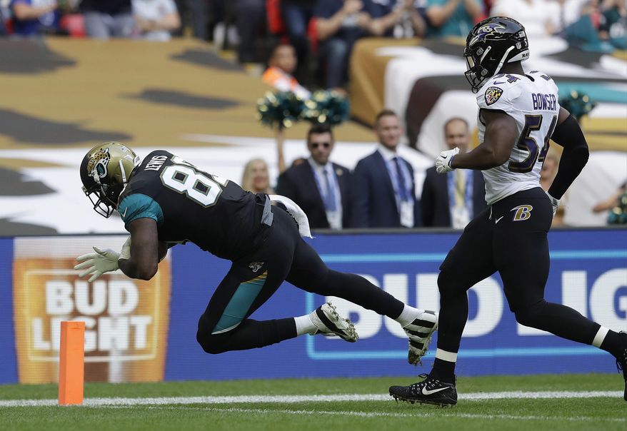 Jacksonville Jaguars tight end Marcedes Lewis (89) scores a touchdown in front of Baltimore Ravens linebacker Tyus Bowser during the first half of an NFL football game at Wembley Stadium in London, Sunday Sept. 24, 2017. (AP Photo/Matt Dunham)