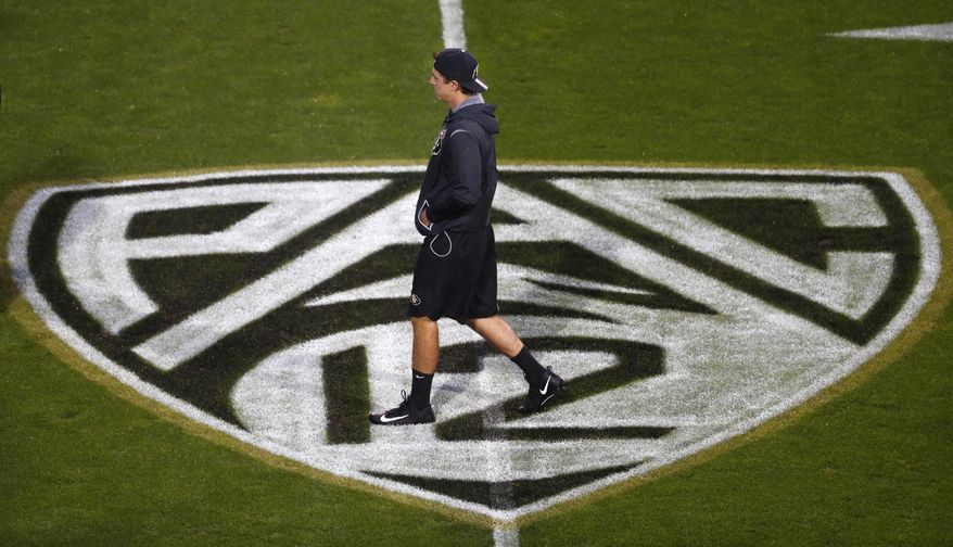 A Colorado player checks the field as rain falls at Folsom Field before Colorado played Washington in an NCAA college football game Saturday, Sept. 23, 2017, in Boulder, Colo. (AP Photo/David Zalubowski)