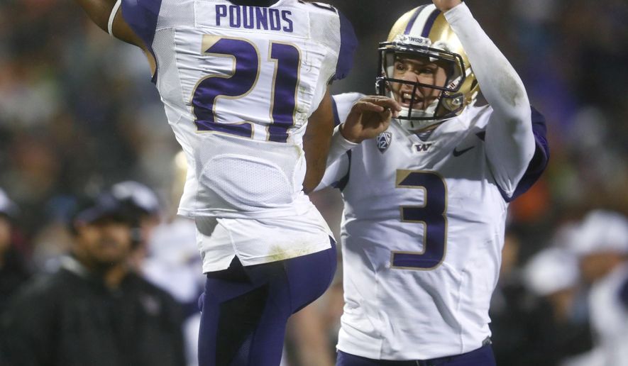 Washington wide receiver Quinten Pounds, left, celebrates his touchdown catch with quarterback Jake Browning during the second half against Colorado in an NCAA college football game Saturday, Sept. 23, 2017, in Boulder, Colo. Washington won 37-10. (AP Photo/David Zalubowski)