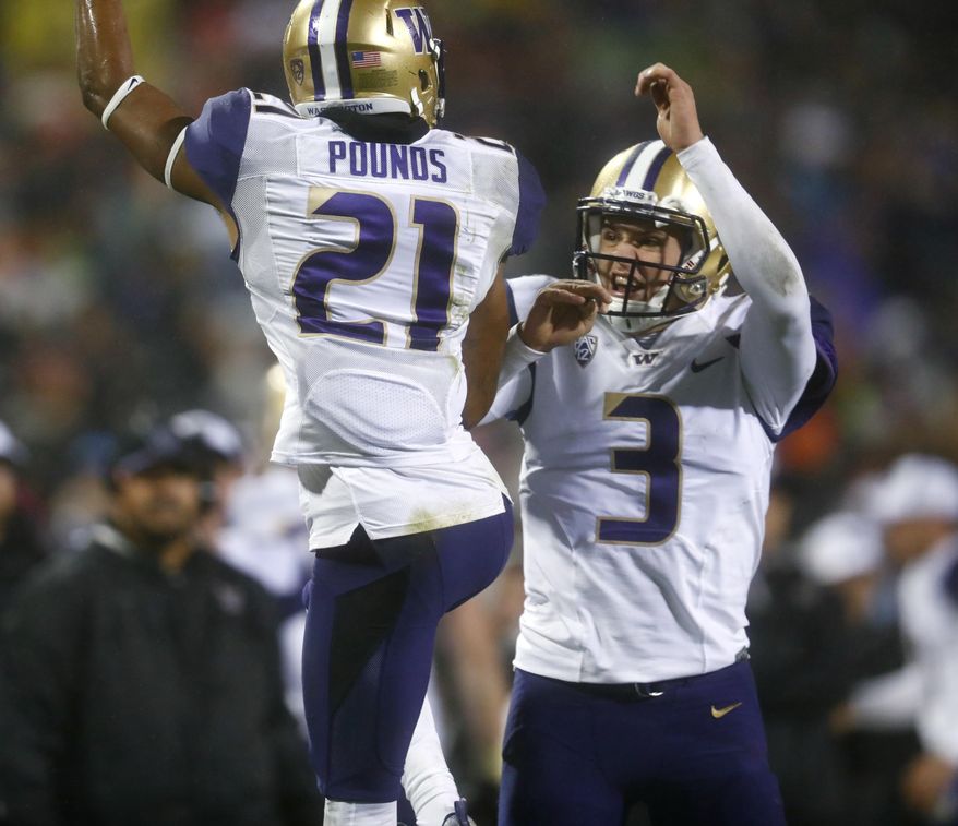 Washington wide receiver Quinten Pounds, left, celebrates his touchdown catch with quarterback Jake Browning during the second half against Colorado in an NCAA college football game Saturday, Sept. 23, 2017, in Boulder, Colo. Washington won 37-10. (AP Photo/David Zalubowski)