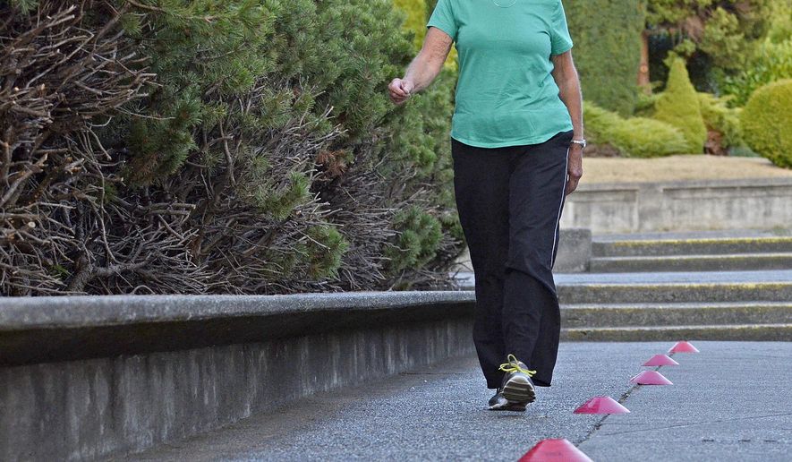 Recovering cancer patient Lynn Laurel does a six minute walk Thursday, Sept. 13, 2017, during her Skagit Valley YMCA LIVESTRONG at the YMCA class. Before her cancer, Lynn Laurel walked 4 miles every day. Now, about a year after her diagnosis, Laurel is working hard to find her way back to a healthy lifestyle. The program, LIVESTRONG at the YMCA, is offered at 211 YMCAs in 39 states and has served about 41,000 cancer patients, according to a YMCA fact sheet. The free program is targeted for people who are or have been in treatment for cancer. (Scott Terrell /Skagit Valley Herald via AP)