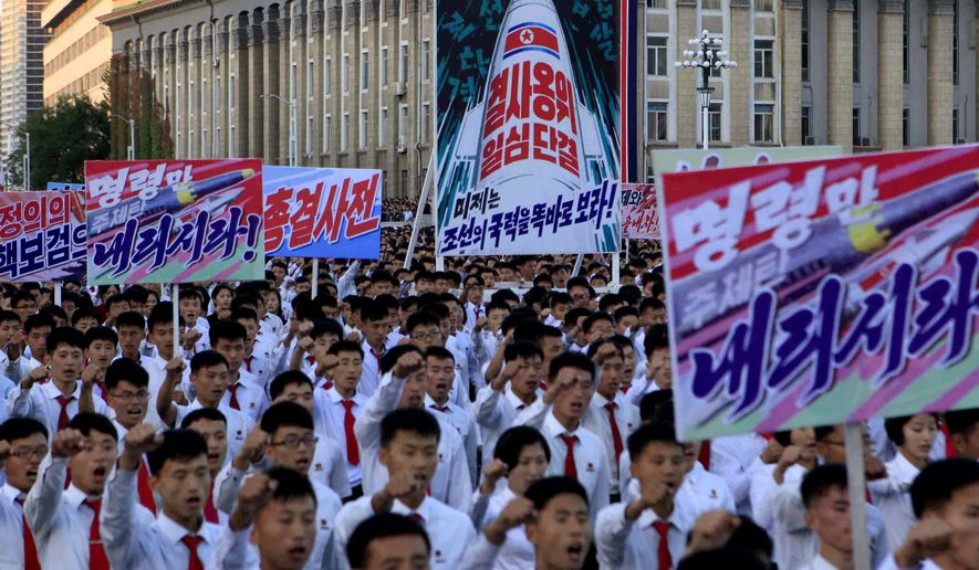 Hundreds of thousands of North Koreans gathered at Kim Il Sung Square to attend a mass rally against America on Saturday Sept. 23, 2017, in Pyongyang, North Korea, a day after the country&#x27;s leader issued a rare statement attacking Donald Trump. Seen on the sign with the painting of a rocket in the center are Korean words which read &quot;defend until the death, single hearted unity&quot; and below it in blue &quot;the American imperialists should see clearly the power of our country&quot;, the sign in the foreground right reads &quot;please give us the order.&quot; (AP Photo/Jon Chol Jin)