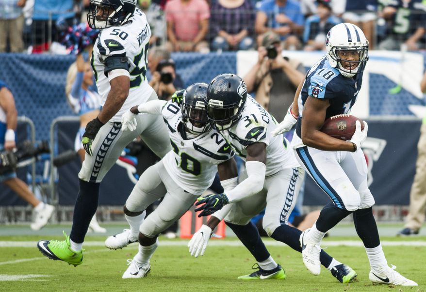 Tennessee Titans wide receiver Rishard Matthews (18) spins out of Seattle Seahawks strong safety Kam Chancellor&#39;s (31) tackle on his way to a touchdown during an NFL football game in Nashville, Tenn., Sunday, Sept. 24, 2017. The Titans won, 33-27. (Austin Anthony/Daily News via AP)