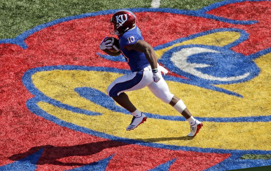 Kansas running back Khalil Herbert (10) runs the ball to score a touchdown during the first half of an NCAA college football game against the West Virginia, Saturday, Sept. 23, 2017, in Lawrence, Kan. (AP Photo/Charlie Riedel)