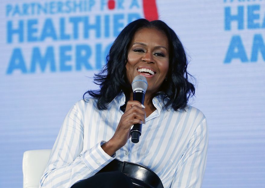 In this May 12, 2017, file photo, former first lady Michelle Obama smiles while speaking at the Partnership for a Healthier American 2017 Healthier Future Summit in Washington. (AP Photo/Pablo Martinez Monsivais, File)