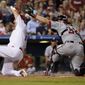 Philadelphia Phillies&#39; Tommy Joseph, left, scores past the tag from Washington Nationals catcher Matt Wieters on a two-run double by Cameron Rupp during the third inning of a baseball game, Tuesday, Sept. 26, 2017, in Philadelphia. (AP Photo/Matt Slocum)