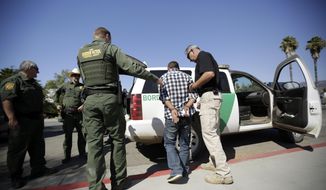 A man is detained by Border Patrol officials after breaching border fencing separating San Diego from Tijuana, Mexico, Tuesday, Sept. 26, 2017, in San Diego. The man, who said he was from Chiapas, Mexico, was detained by agents as they prepared for a news conference to announce that contractors have begun building eight prototypes of President Donald Trump&#39;s proposed border wall with Mexico. (AP Photo/Gregory Bull)