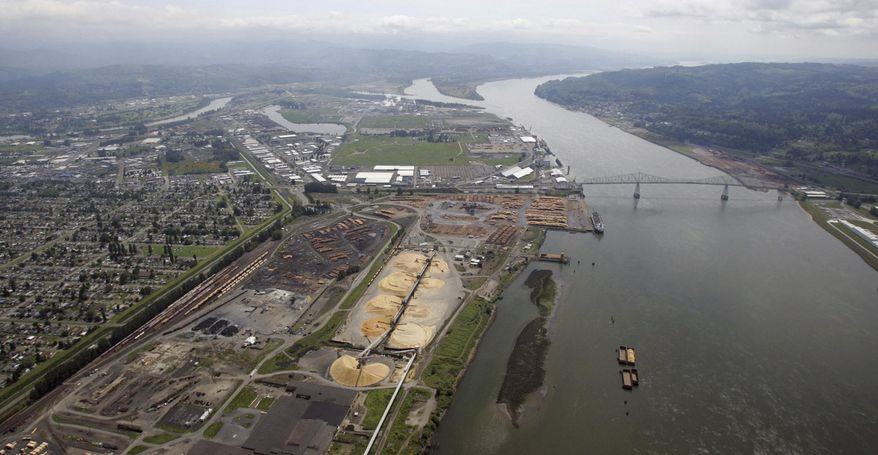 FILE- This May 12, 2005, file photo, shows the port of Longview on the Columbia River at Longview, Wash. The Department of Ecology said Tuesday, Sept. 26, 2017, it rejected a water quality permit that Millennium Bulk Terminals wanted because the proposed facility near Longview in southwest Washington state would have caused "significant and unavoidable harm" to the environment. (AP Photo/Elaine Thompson, File)