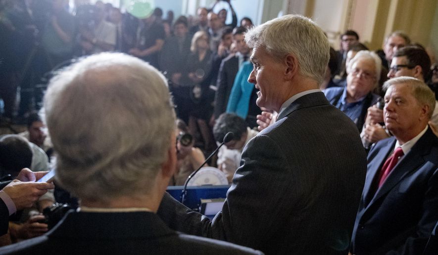 Sen. Bill Cassidy, R-La., flanked by Sen. Lindsey Graham, R-S.C., right, and Senate Majority Leader Mitch McConnell, R-Ky., left, speaks to reporters as they faced assured defeat on the Graham-Cassidy bill, the GOP&#39;s latest attempt to repeal the Obama health care law, at the Capitol in Washington, Tuesday, Sept. 26, 2017, in Washington. The decision marked the latest defeat on the issue for President Donald Trump and Senate Majority Leader Mitch McConnell in the Republican-controlled Congress. (AP Photo/Andrew Harnik)