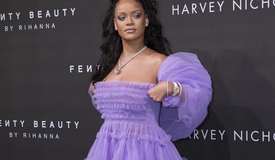 FILE - In this Sept. 19, 2017 file photo, singer Rihanna poses for photographers upon arrival at the Fenty Beauty by Rihanna fashion range launch during London Fashion Week in London. (Photo by Vianney Le Caer/Invision/AP, File)