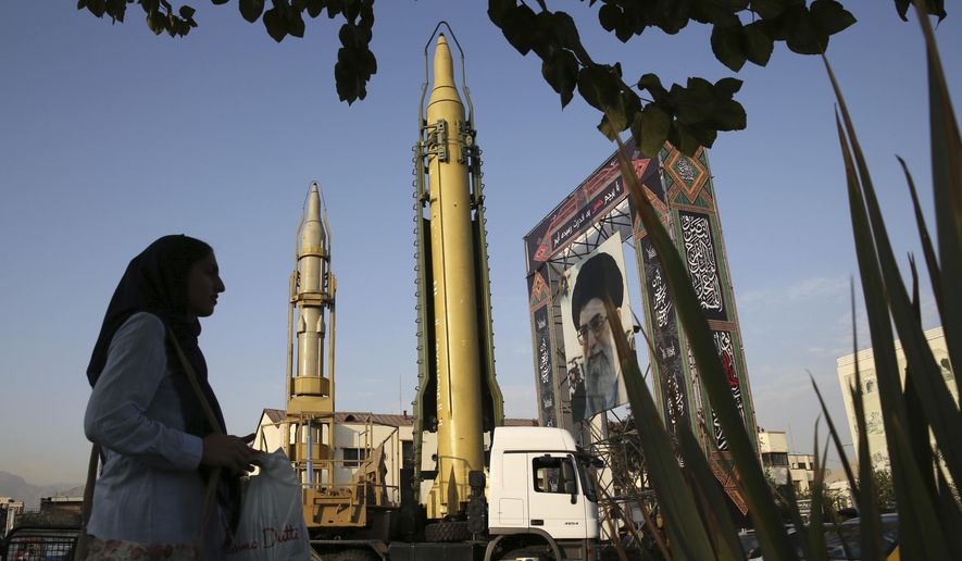 A Ghadr-H missle, center, a solid-fuel surface-to-surface Sejjil missile and a portrait of the Supreme Leader Ayatollah Ali Khamenei are on display for the annual Defense Week, marking the 37th anniversary of the 1980s Iran-Iraq war, at Baharestan Sq. in Tehran, Iran, Sunday, Sept. 24, 2017. Iran&#x27;s elite Revolutionary Guard displayed the country&#x27;s sophisticated Russian-made S-300 air defense system in public for the first time. (AP Photo/Vahid Salemi)