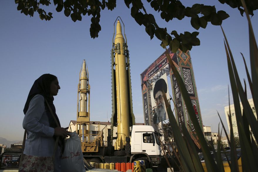 A Ghadr-H missle, center, a solid-fuel surface-to-surface Sejjil missile and a portrait of the Supreme Leader Ayatollah Ali Khamenei are on display for the annual Defense Week, marking the 37th anniversary of the 1980s Iran-Iraq war, at Baharestan Sq. in Tehran, Iran, Sunday, Sept. 24, 2017. Iran's elite Revolutionary Guard displayed the country's sophisticated Russian-made S-300 air defense system in public for the first time. (AP Photo/Vahid Salemi)